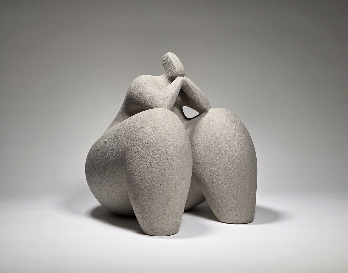Considered Woman, hand-built ceramic sculpture by Rachel Peters, coiled in grey grogged stoneware, left unglazed, showing a seated contemplative female form.