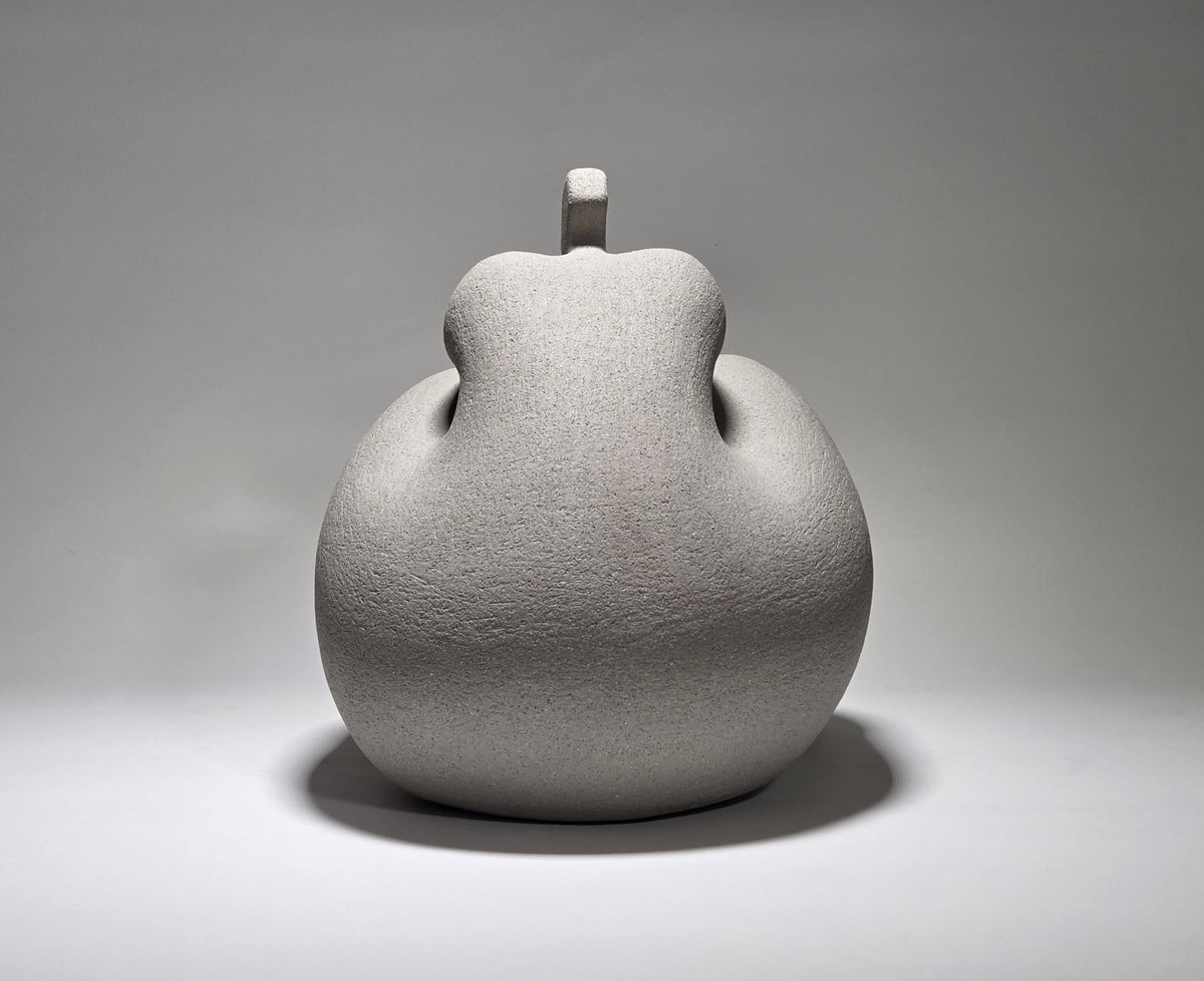 Considered Woman, hand-built ceramic sculpture by Rachel Peters, coiled in grey grogged stoneware, left unglazed, showing a rounded seated female form viewed from the back.