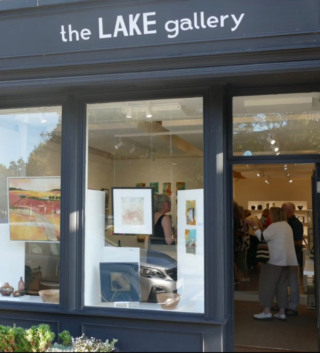 The exterior of The Lake Gallery on the Wirral, with visitors browsing paintings and ceramics inside, where Rachel Peters is now a gallery partner.