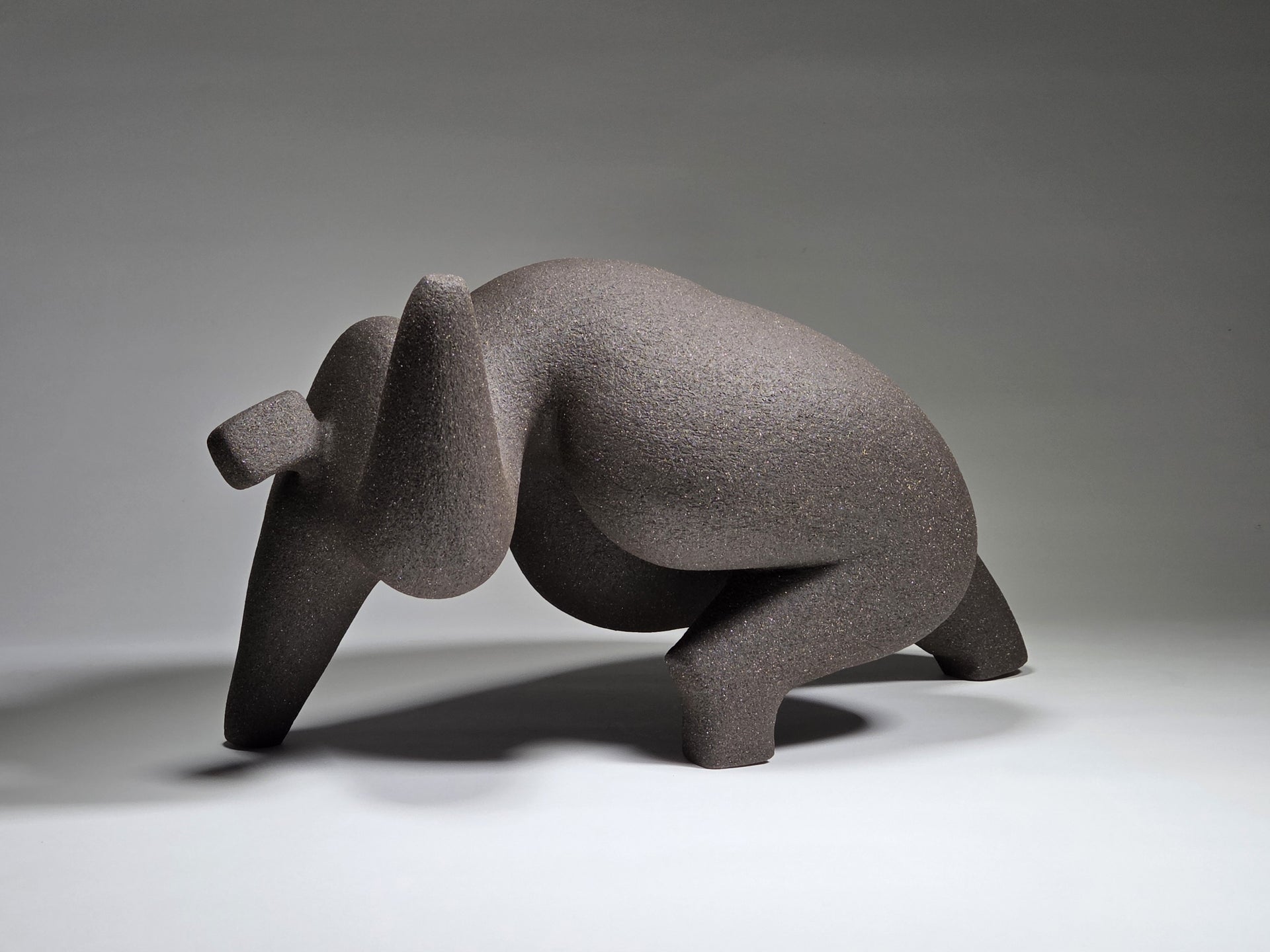 Abstract ceramic woman sculpture on a grey background