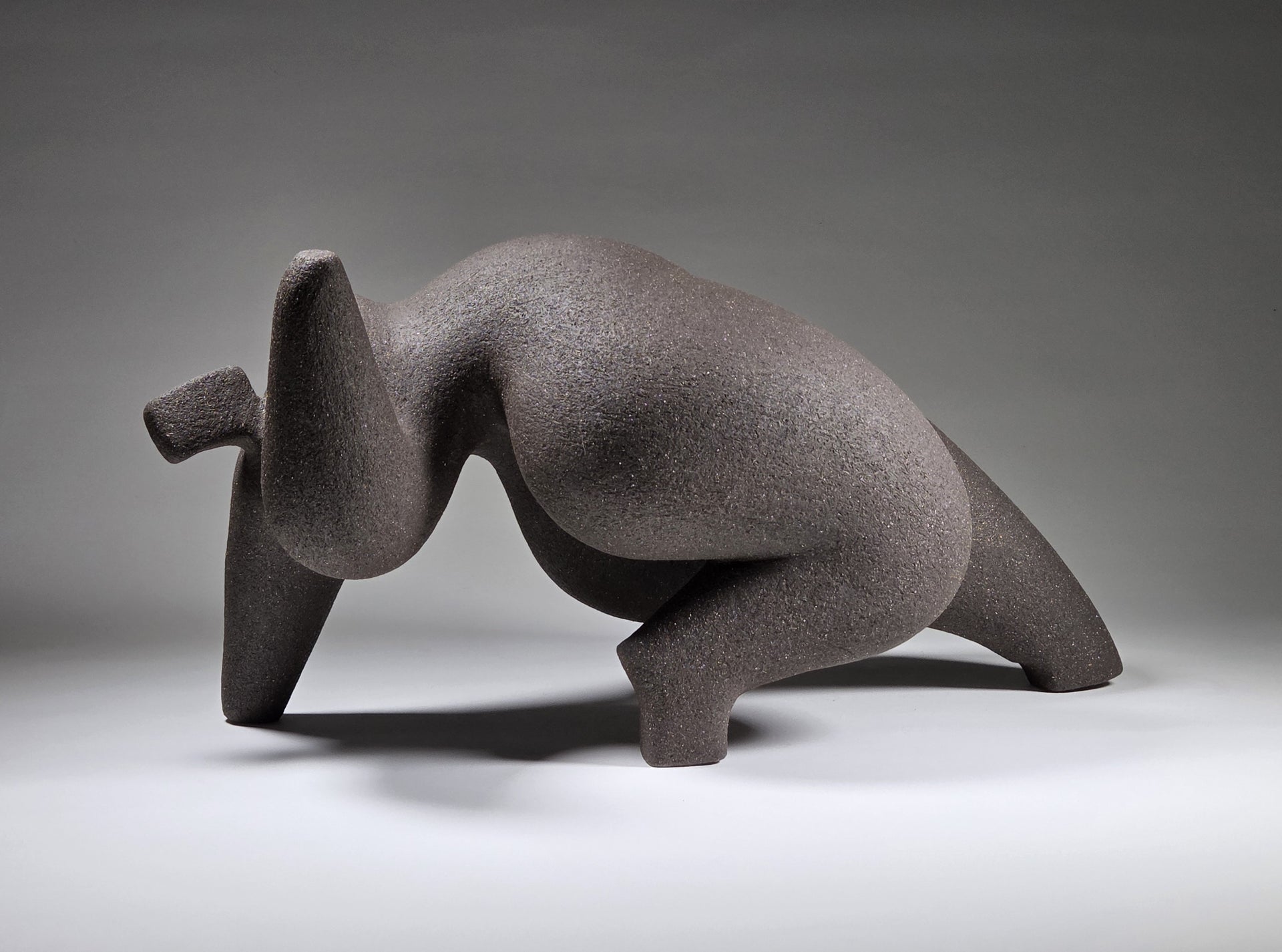 Abstract ceramic woman sculpture on a grey background