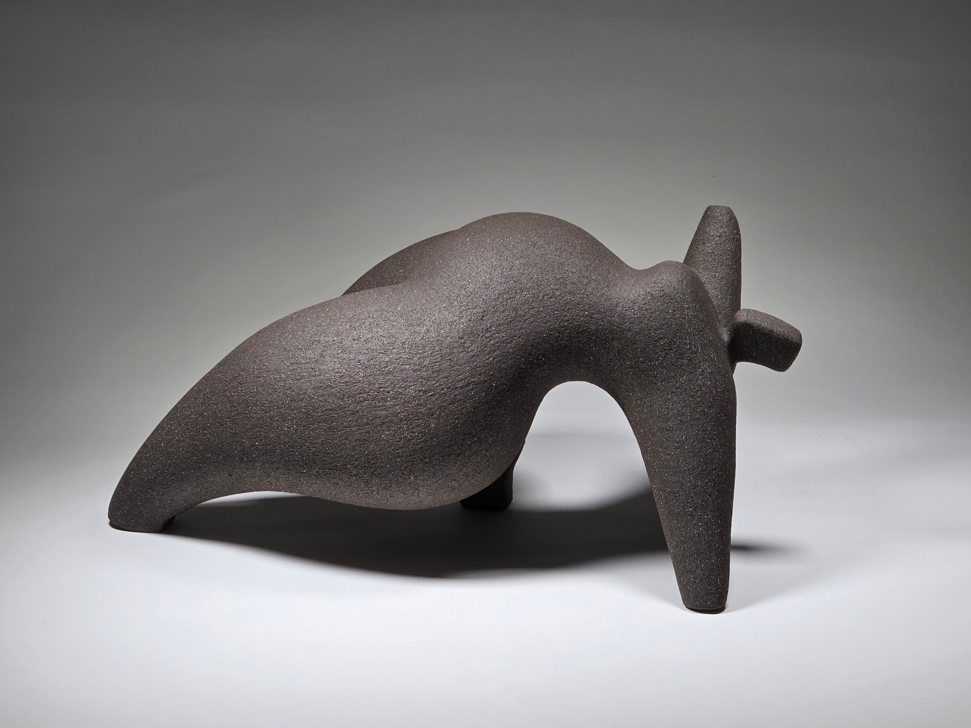 Abstract ceramic woman sculpture on a grey background