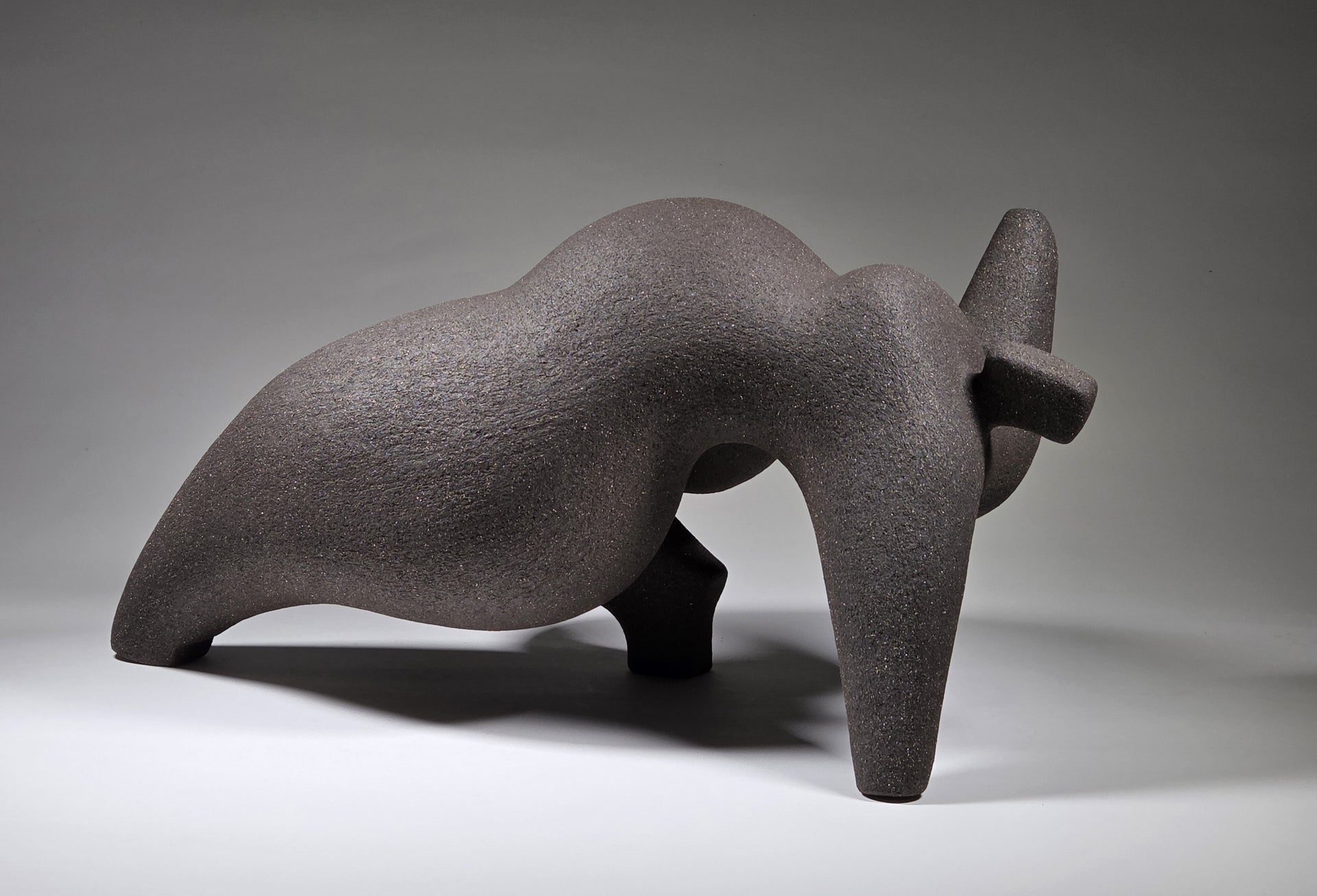 Abstract ceramic woman sculpture on a grey background