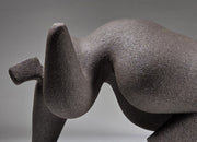 Abstract ceramic woman sculpture on a grey background