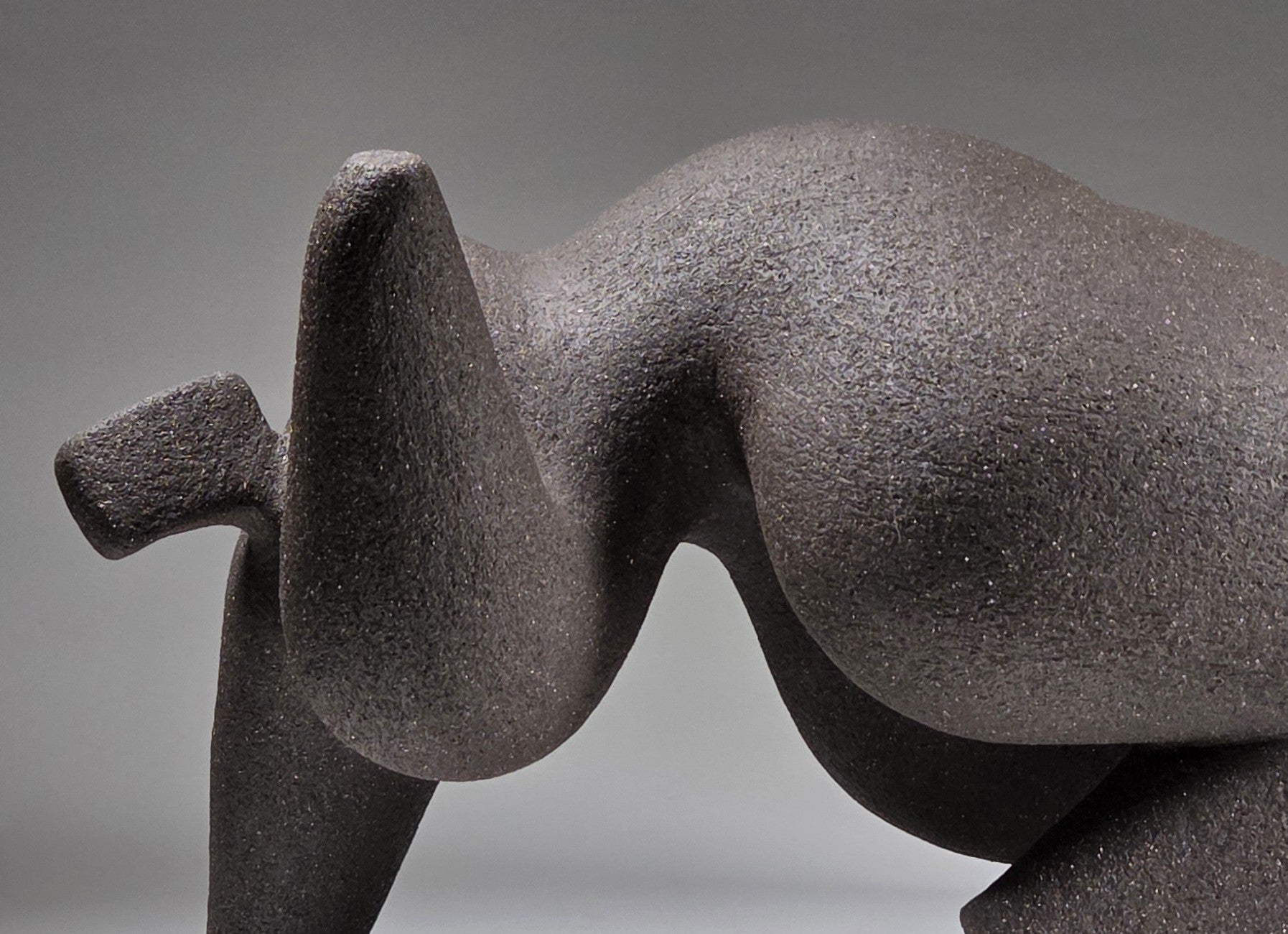 Abstract ceramic woman sculpture on a grey background