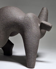 Abstract ceramic woman sculpture on a grey background