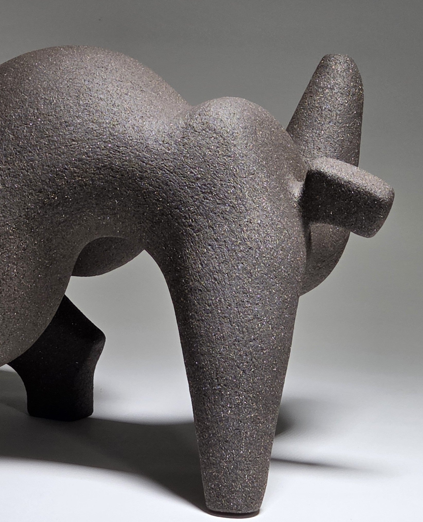 Abstract ceramic woman sculpture on a grey background