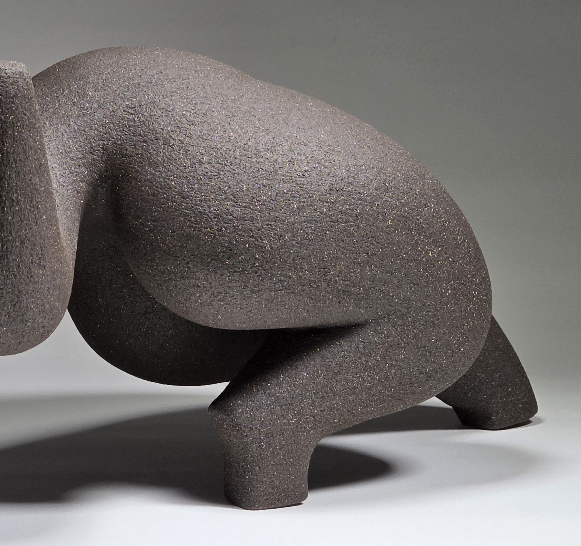 Close up of abstract ceramic woman sculpture on a grey background