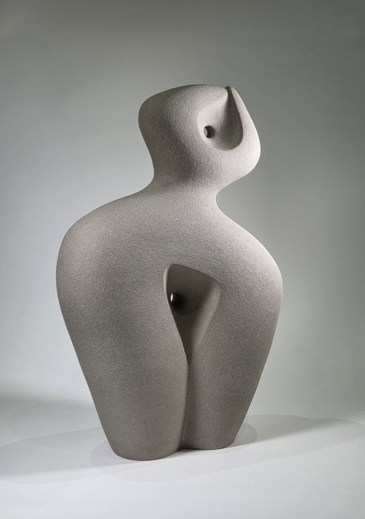 Abstract ceramic sculpture on a grey background