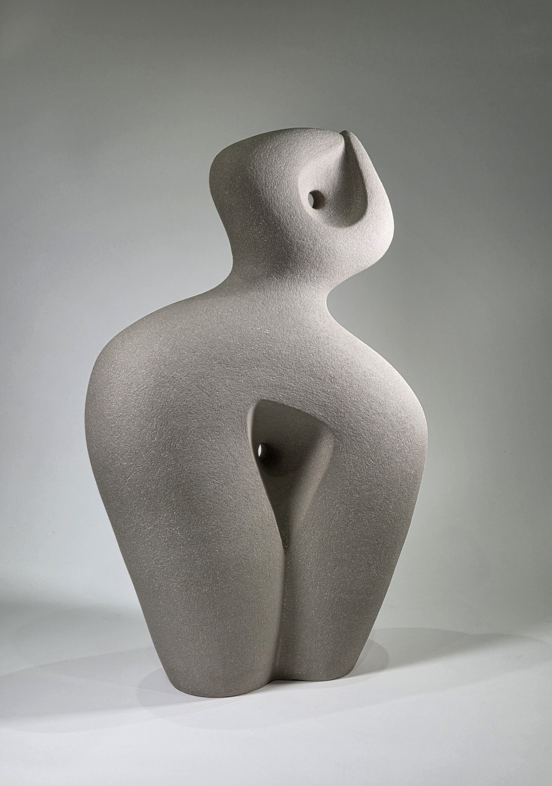 Abstract ceramic sculpture on a grey background