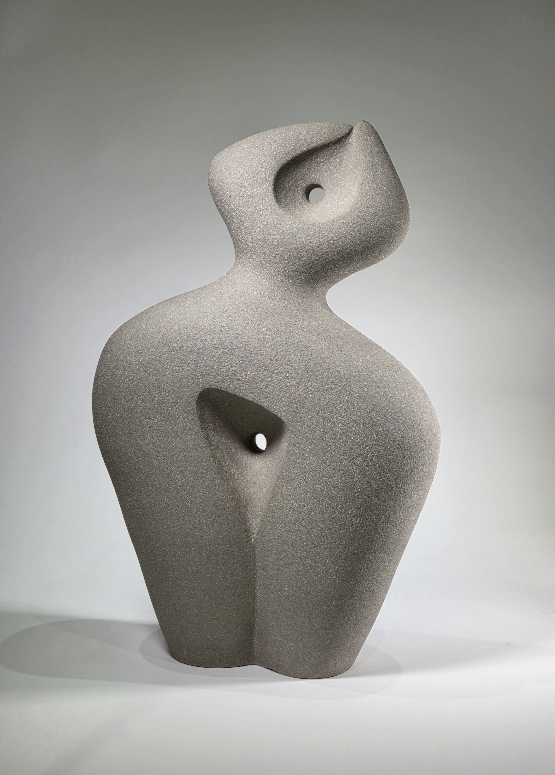 Abstract ceramic sculpture on a grey background