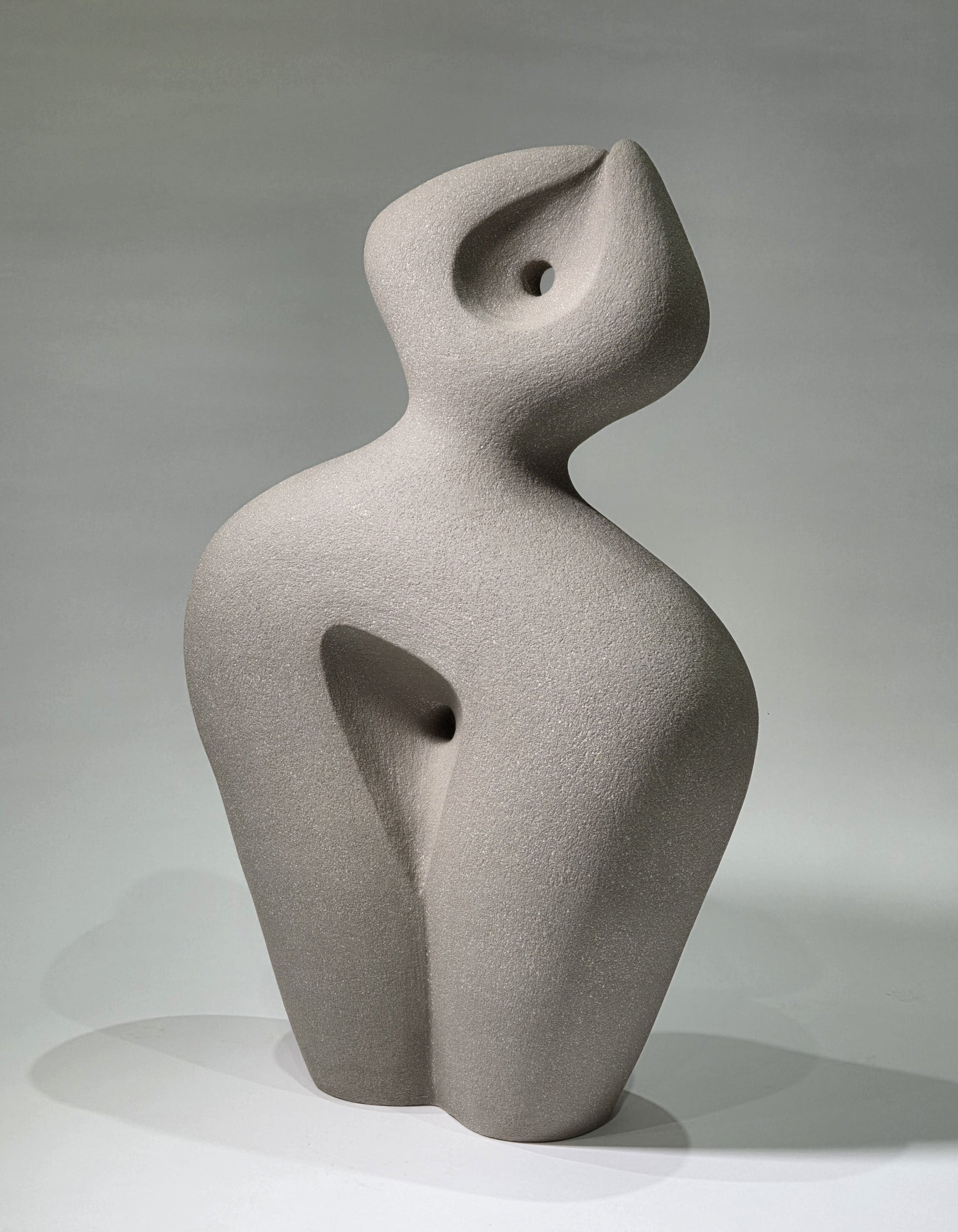 Abstract ceramic sculpture on a grey background