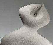 Close up of Abstract ceramic sculpture on a grey background