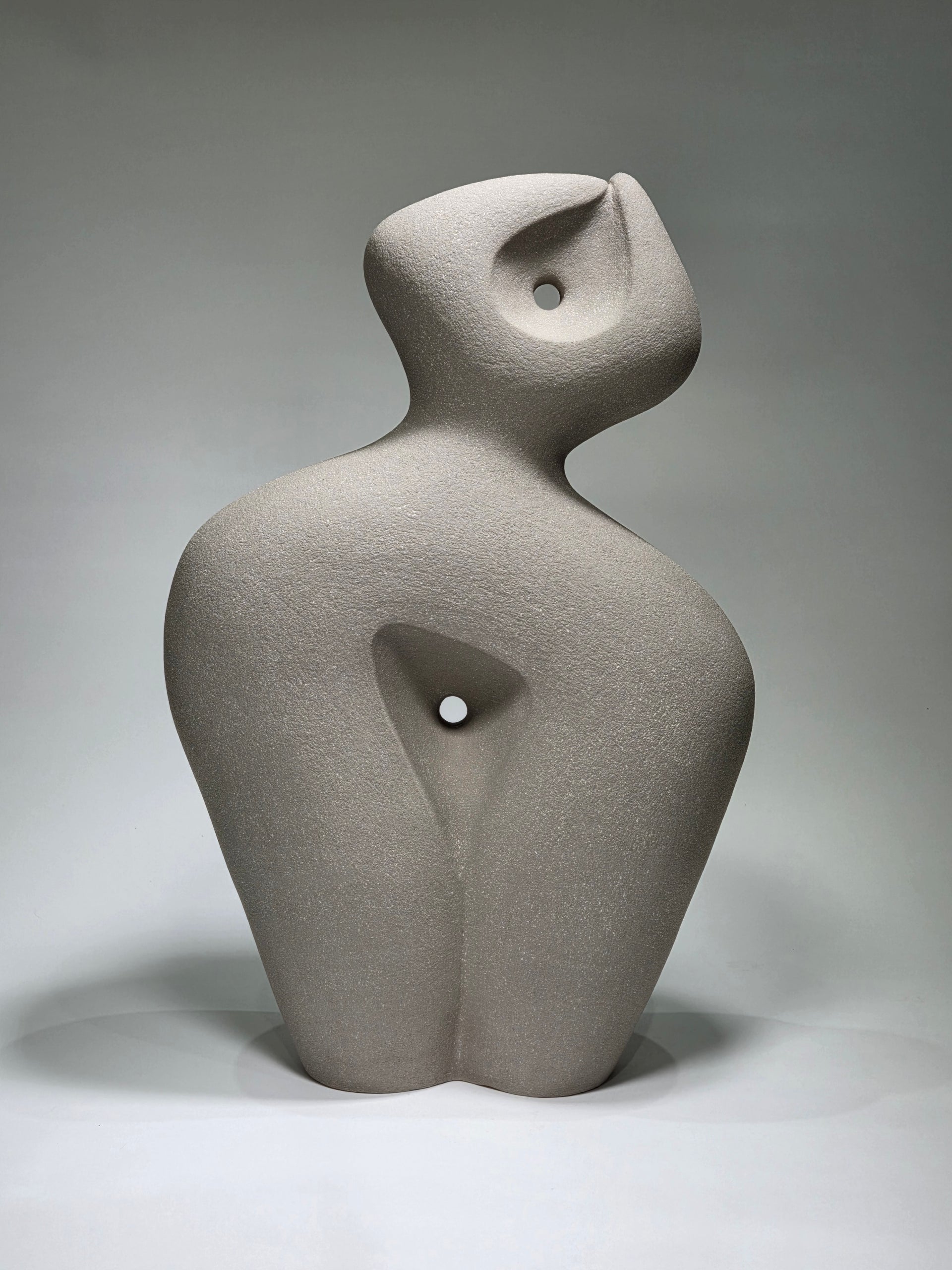 Abstract ceramic sculpture on a grey background