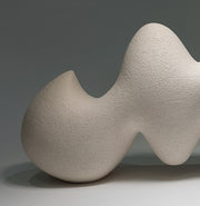 Close up shot of Pulse ceramic sculpture, hand-built white stoneware, rhythmic wave-like form, horizontal composition.