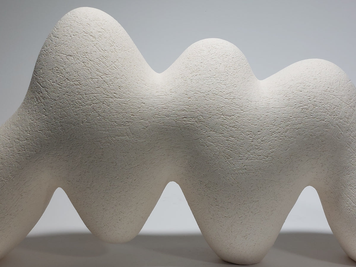 Close up of Pulse ceramic sculpture, hand-built white stoneware, rhythmic wave-like form, horizontal composition.