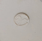 Circular logo with a stylized design on a light gray background