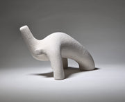 Abstract white ceramic figure arching backwards with one arm on the floor and one stretched upwards pictures on a light grey background